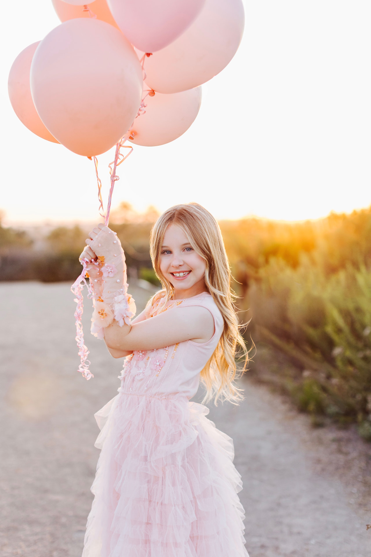 Goldie Teagan holding pink balloons